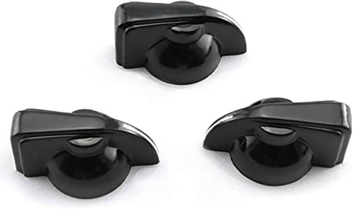 Black chicken-head guitar amp potentiometer knobs, close-up of three faces