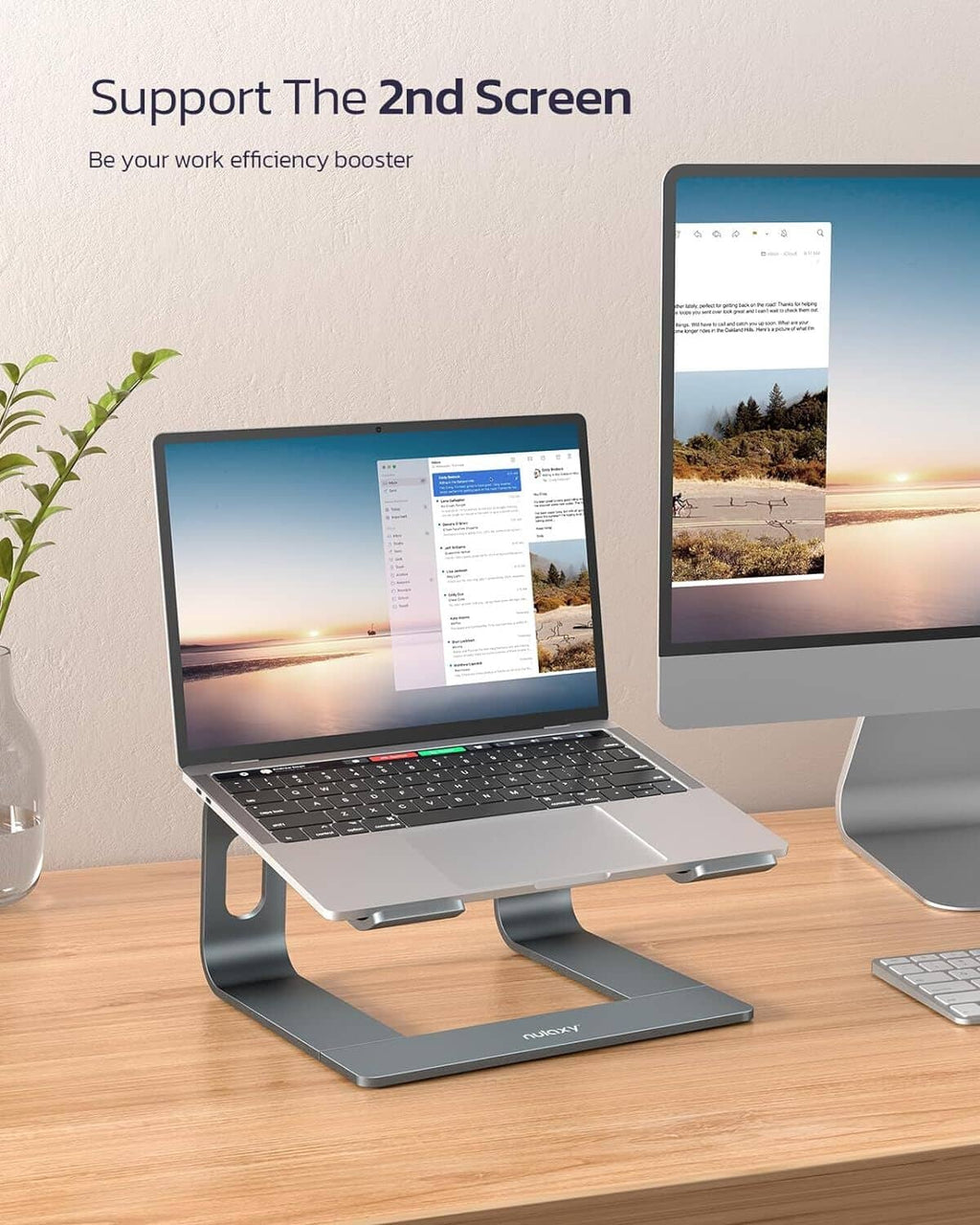 Dark gray laptop stand riser supporting a laptop and second-screen layout