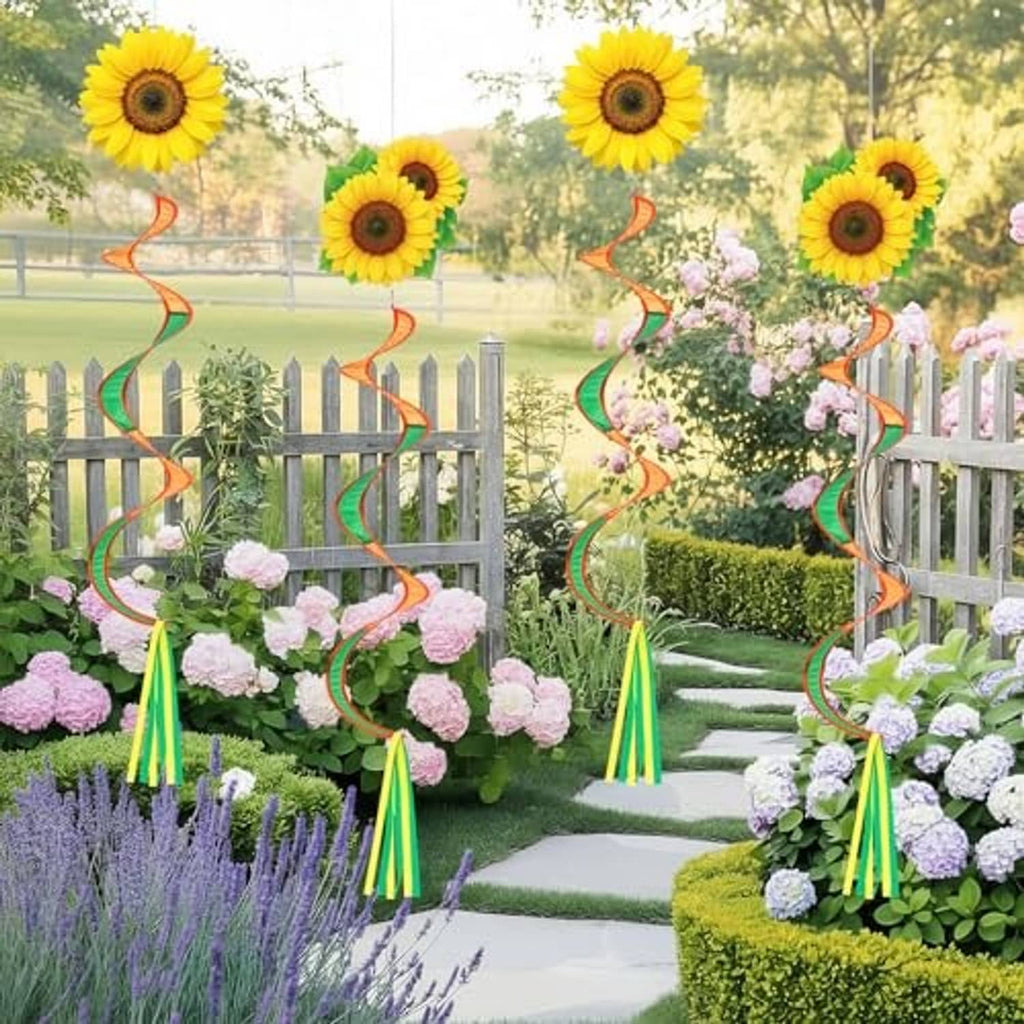 Sunflower windsock hanging decor with orange-green ribbon spirals among garden flowers