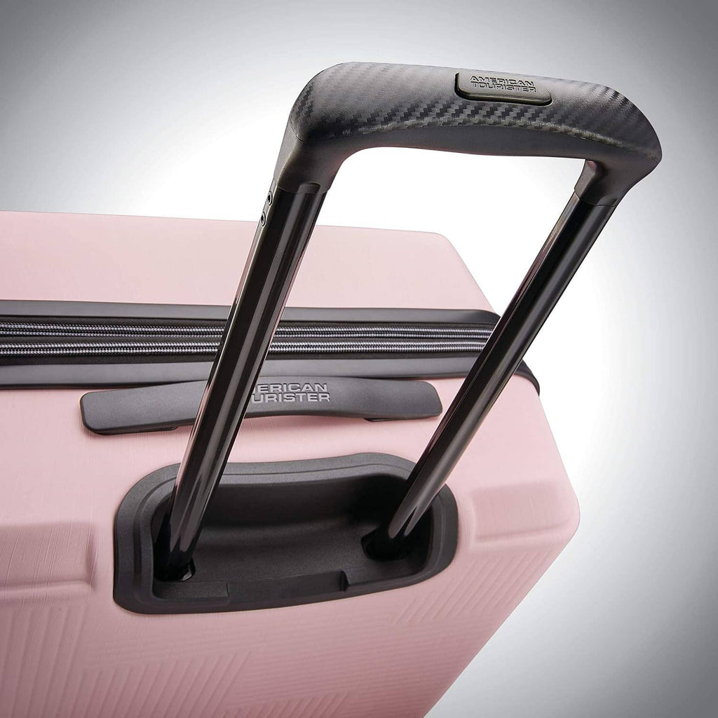 Pink hard-shell luggage top handle with American Tourister logo label