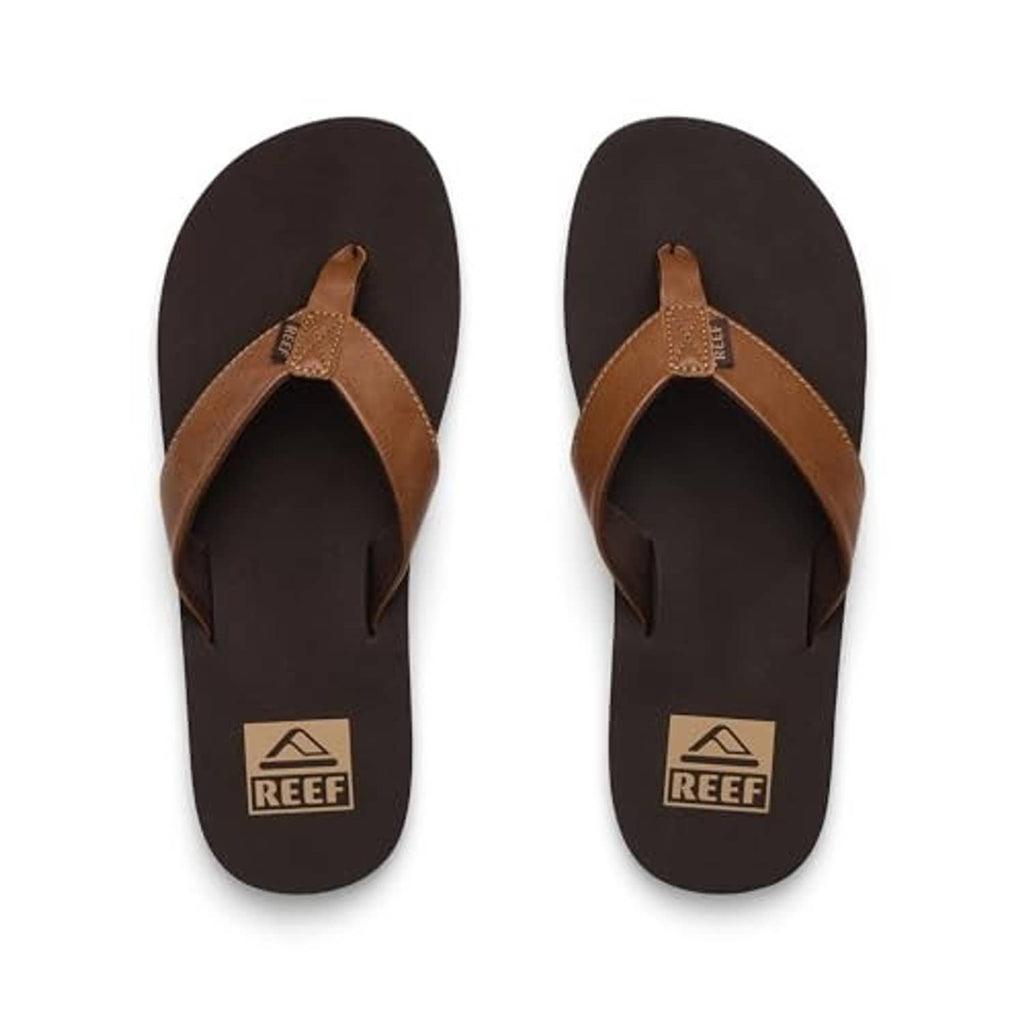 Pair of brown flip-flop sandals with tan thong straps and REEF logo footbed.