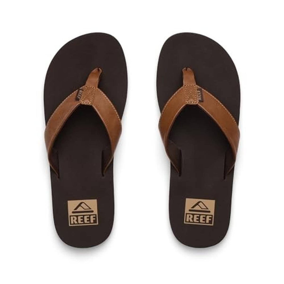 Pair of brown flip-flop sandals with tan thong straps and REEF logo footbed.