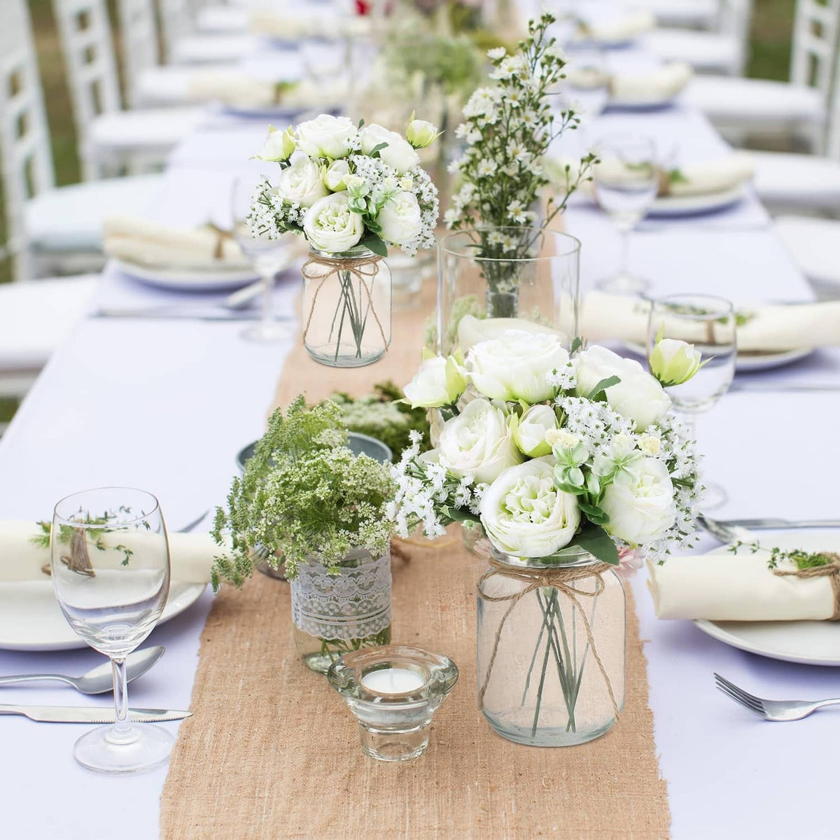 Mason jar centerpiece set with faux white roses, baby breath, and green foliage