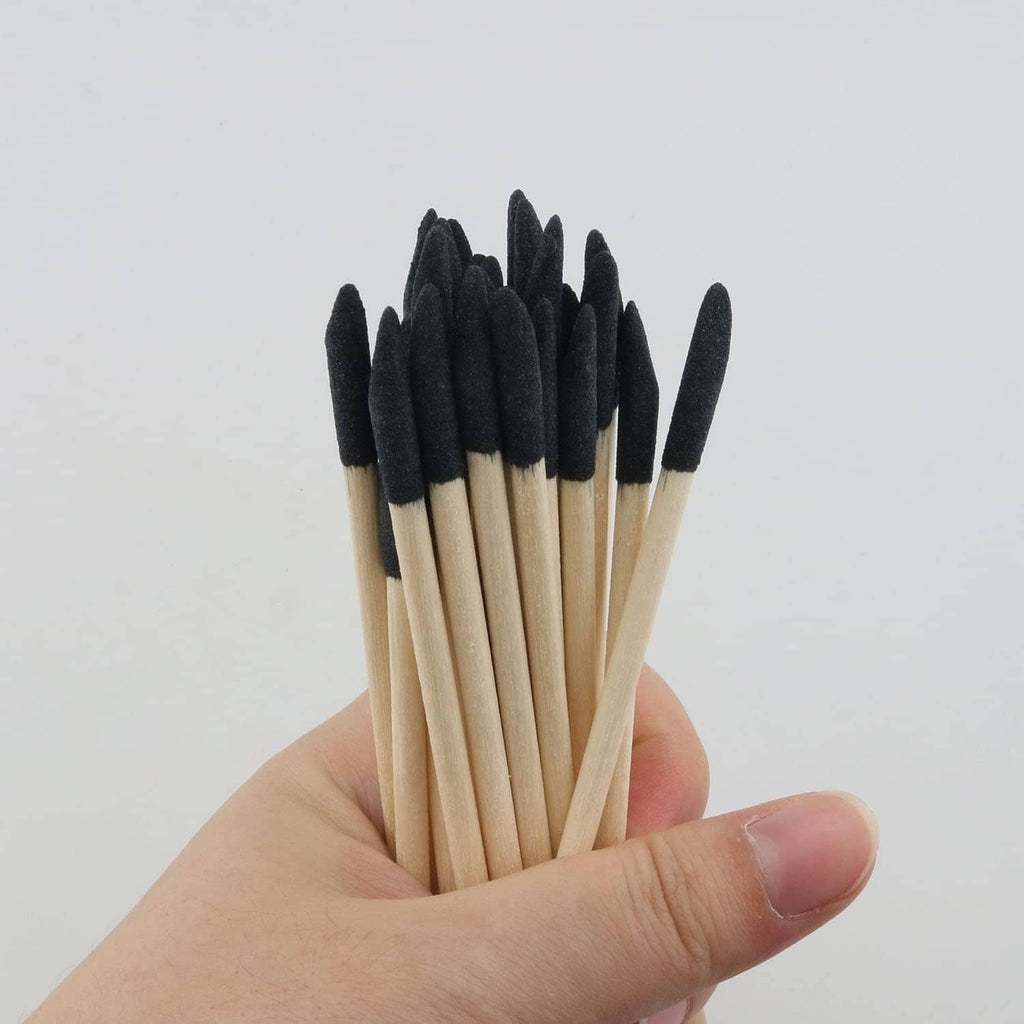 Sanding sticks bundle with black abrasive heads and pale wooden pointed stems