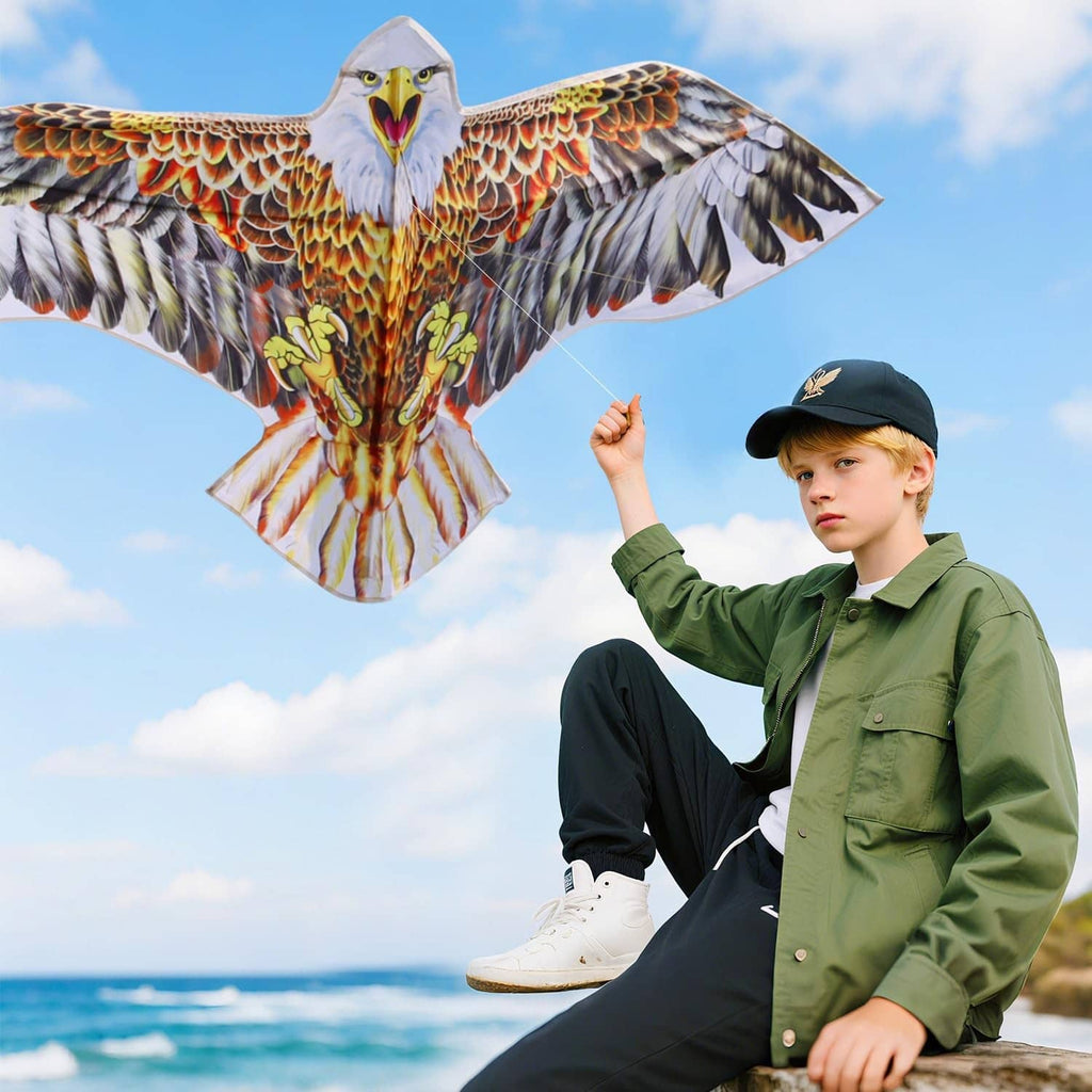 Eagle kite with brown wing feathers, orange chest, and white head, flying above a child