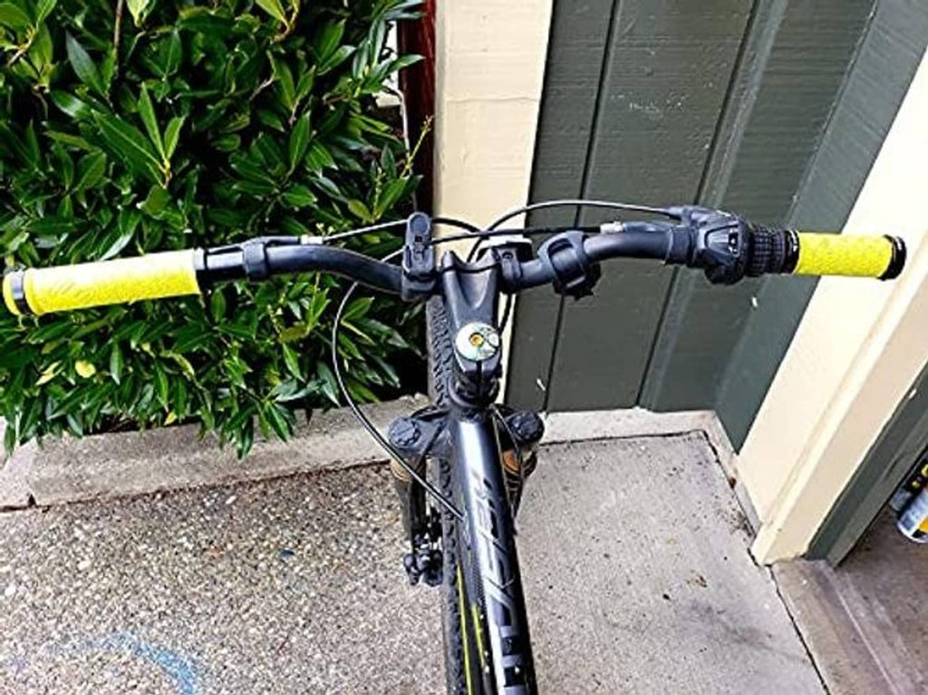 Yellow bicycle handlebar grips with textured pattern and black center bar tape