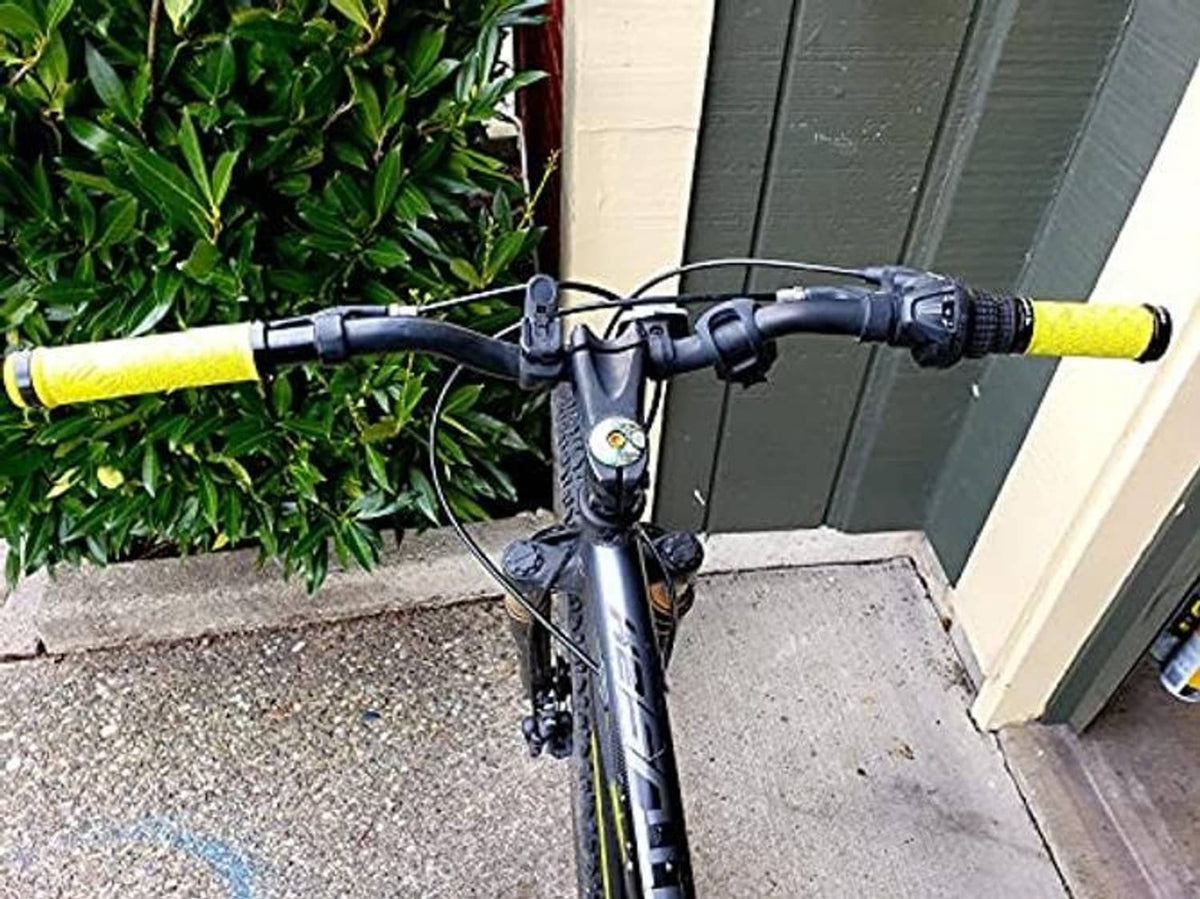 Yellow bicycle handlebar grips with textured pattern and black center bar tape