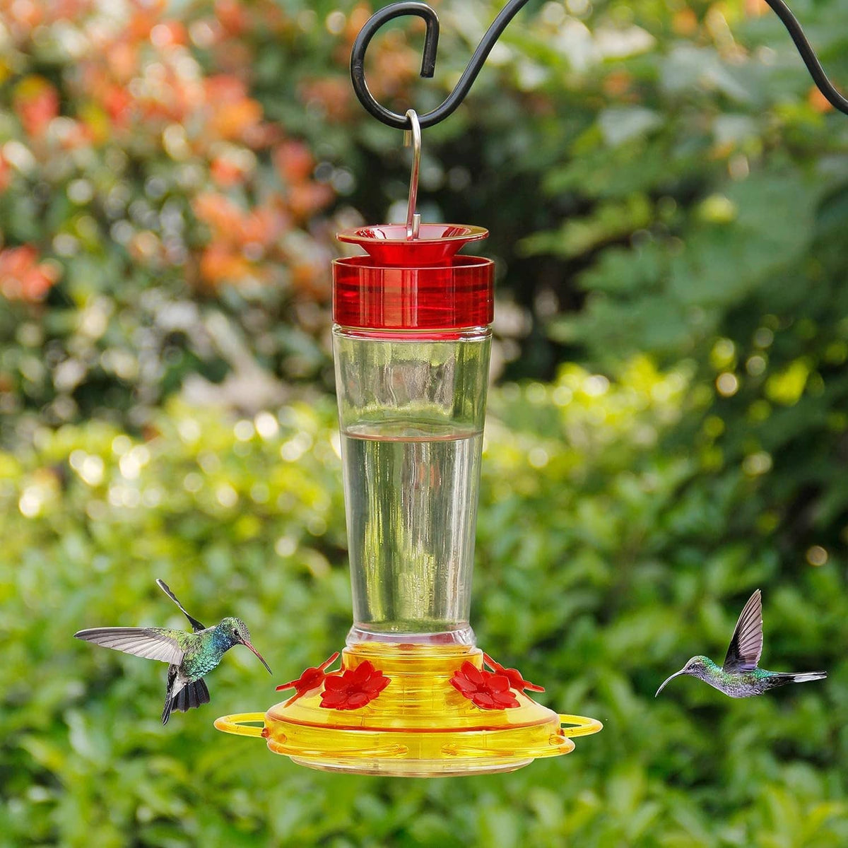 Hanging hummingbird feeder: clear glass bottle with red lid and yellow 5-port tray