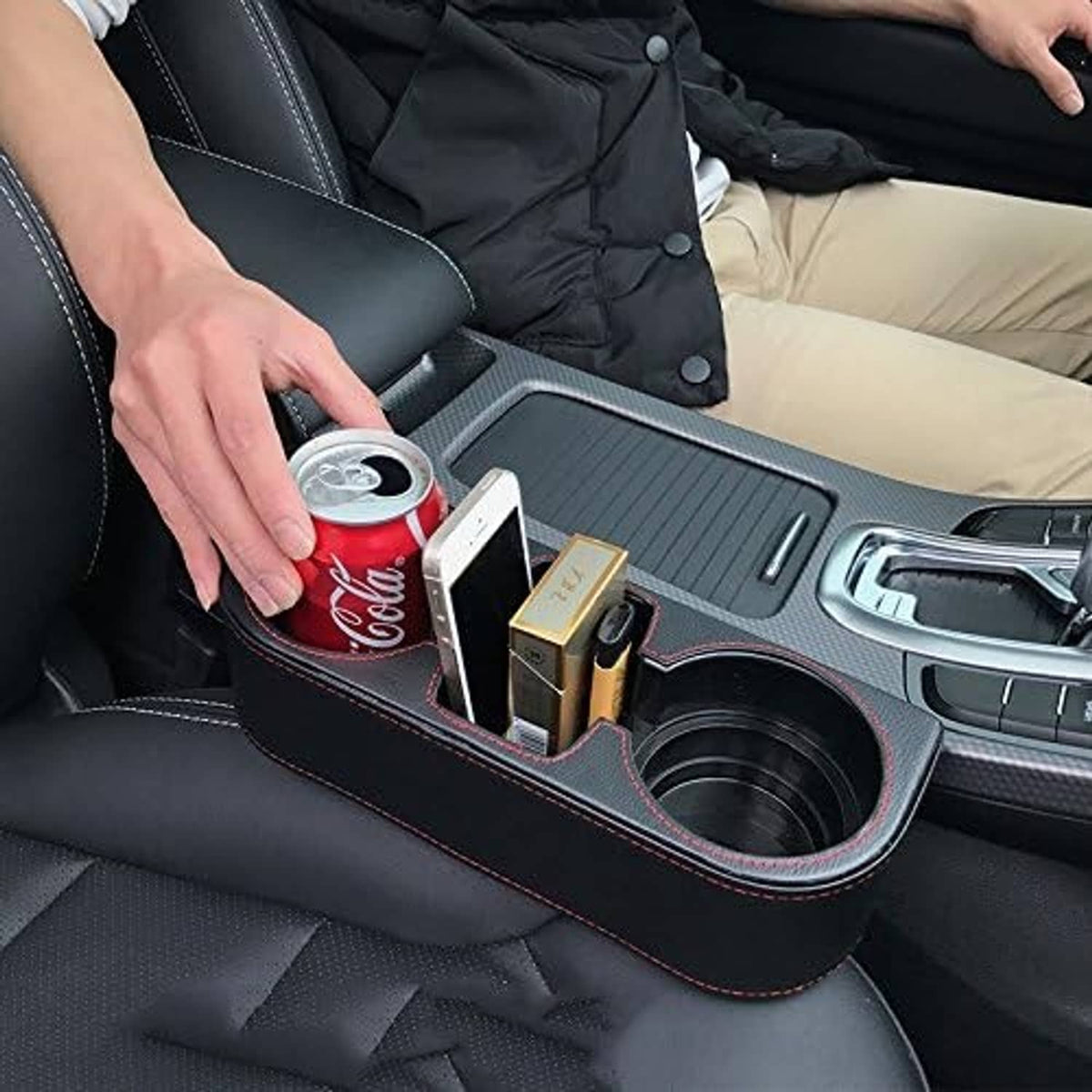 Black car console organizer tray with two cup wells and phone/wallet slots, red stitching
