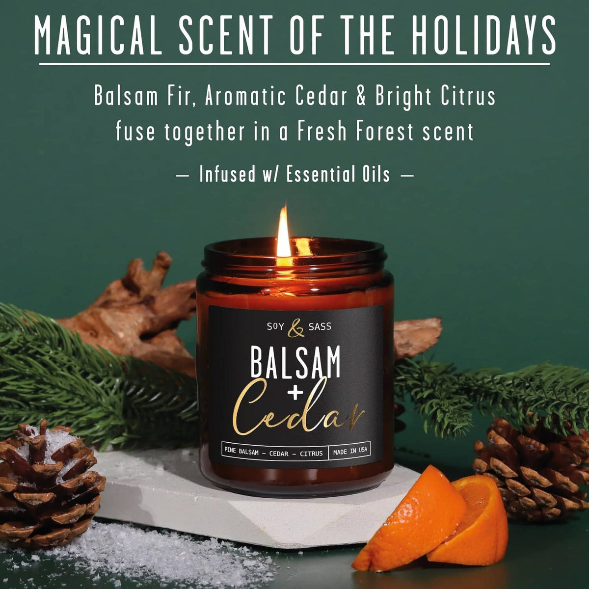 Amber glass soy candle jar with flame on a festive tabletop arrangement