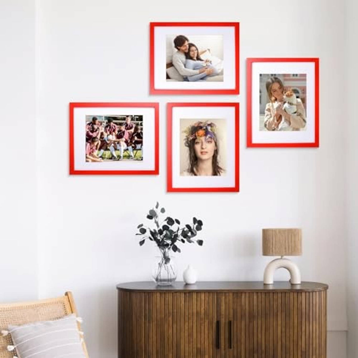 Set of red 11x14 and smaller solid wood picture frames on wall