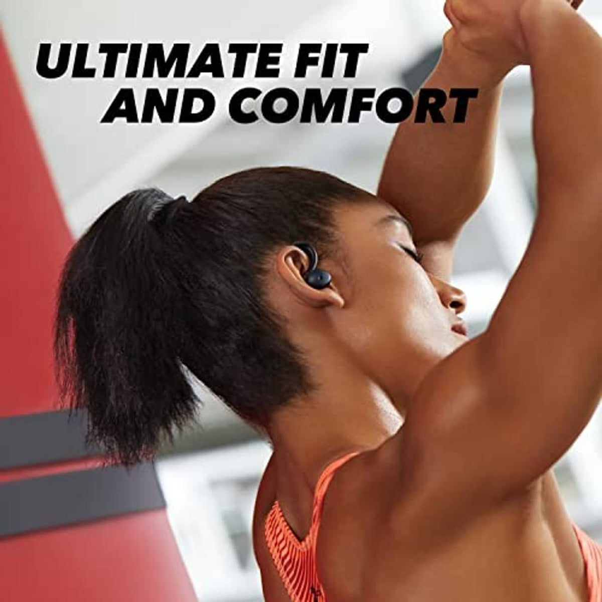 Black sport earbuds worn in-ear with over-ear hook, shown on a runner.