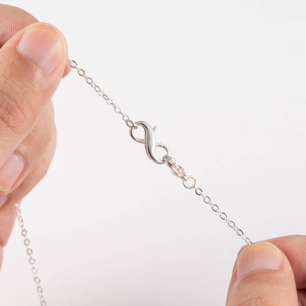 Hand holding sterling silver lobster clasp extender on chain