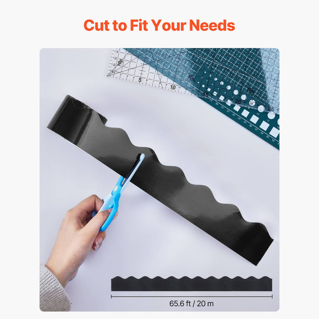 Black scalloped border trim strip with wavy edge, laid flat near a cutting tool