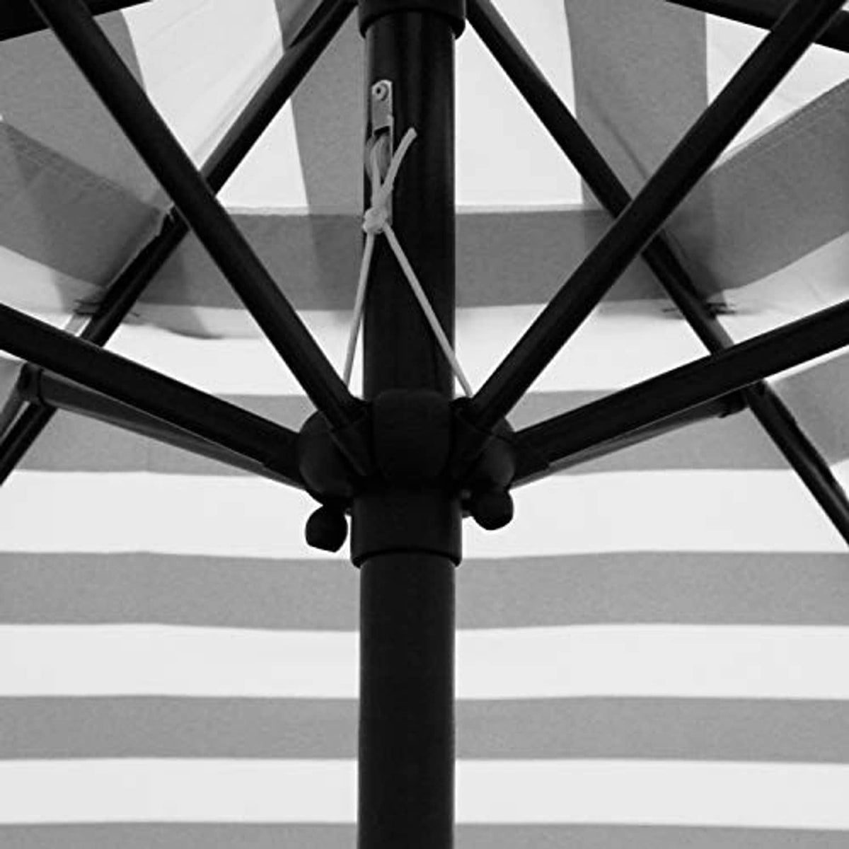 Black patio umbrella canopy with cross ribs and hub at the center pole
