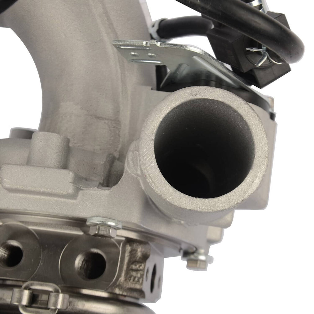 Turbocharger housing close-up with circular intake port and attached metal parts