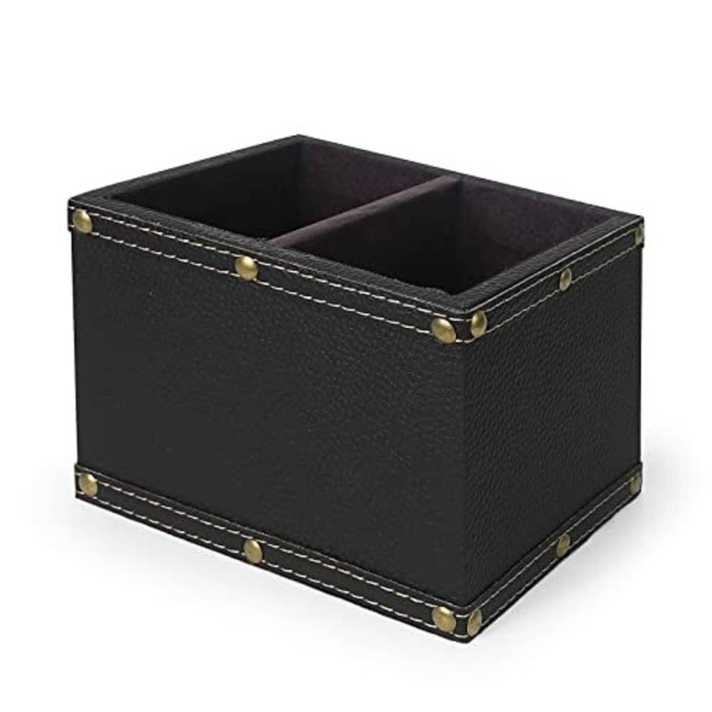 Black leather remote organizer bin with open compartments and brass studs on corners