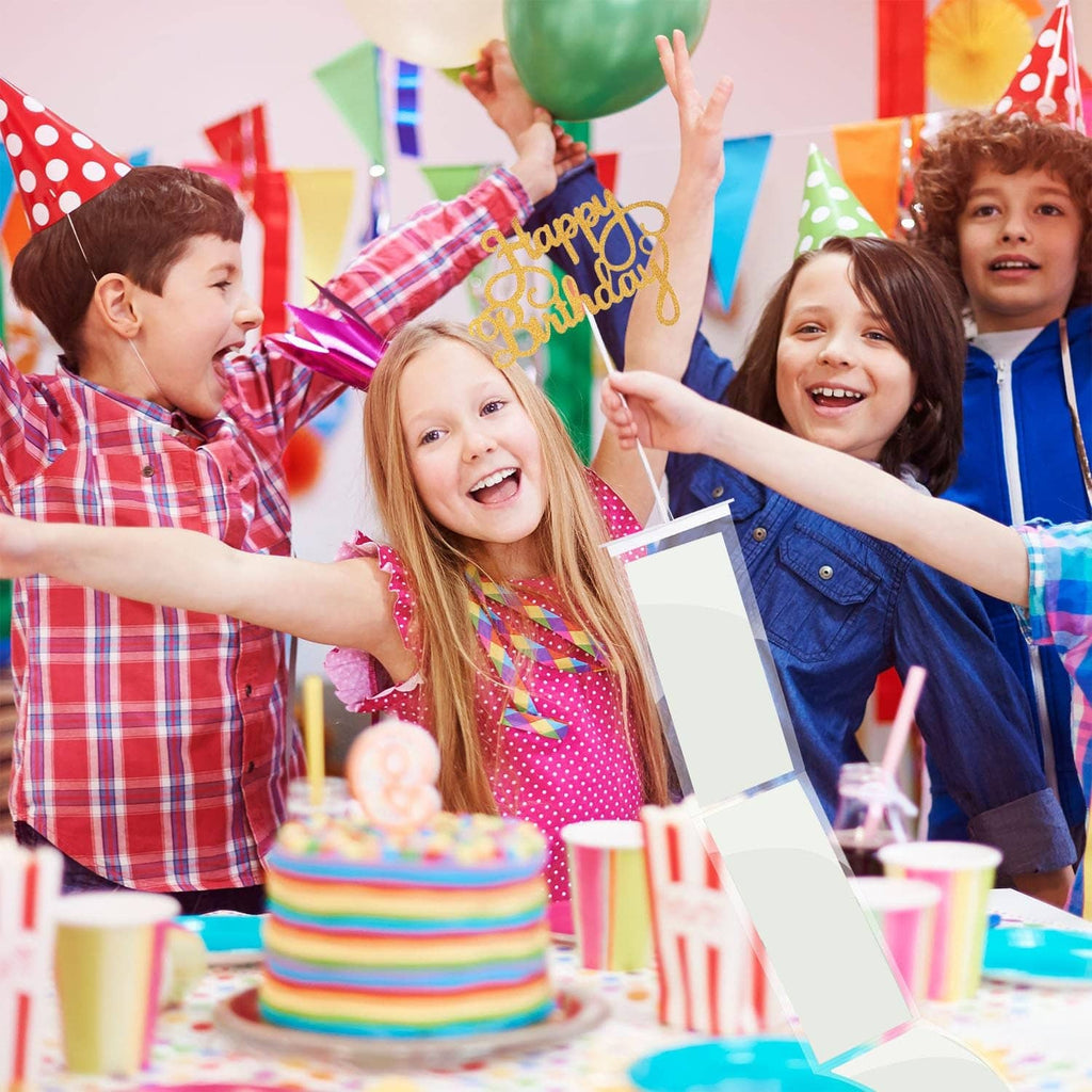 Birthday celebration with kids holding money pull-out cards beside cake