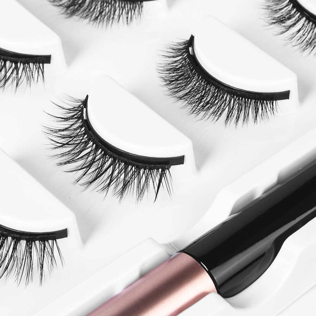 Natural false eyelashes with black eyeliner applicator, several lash pairs shown