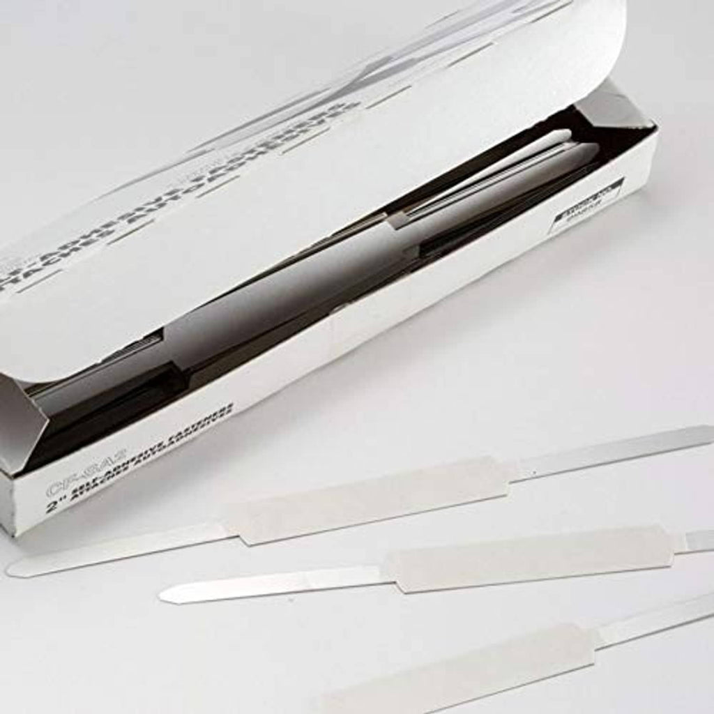 Self-adhesive prong paper fasteners laid out from the package, silver finish