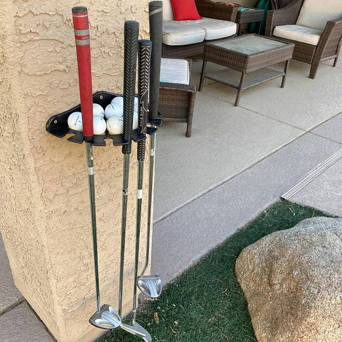 Black golf club organizer rack holding multiple club shafts and a golf ball row.