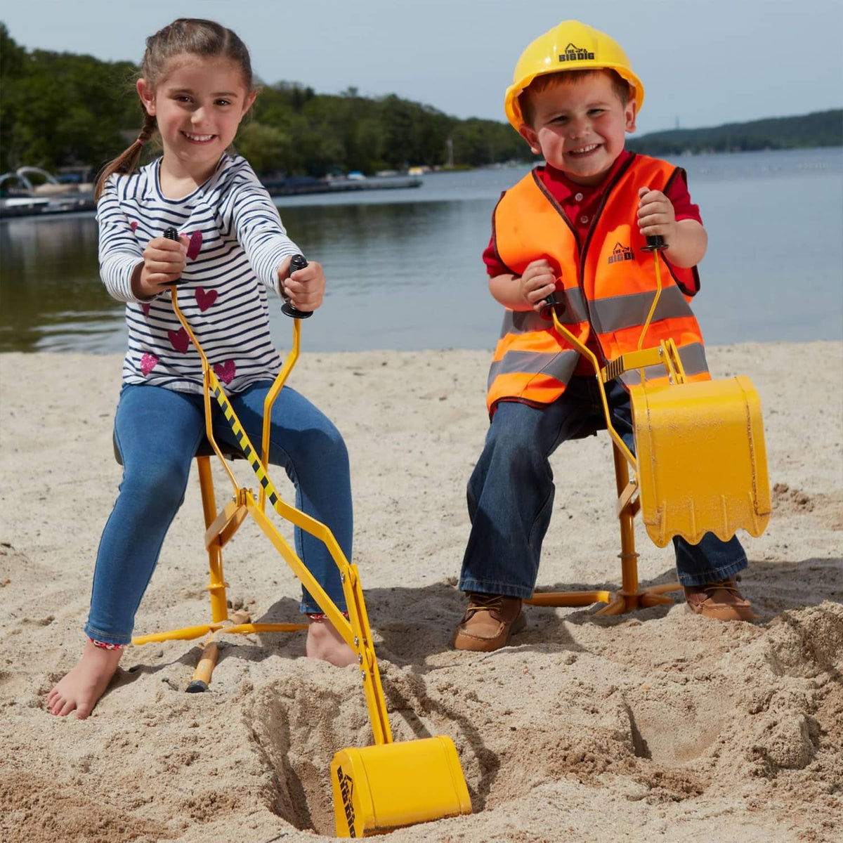 Yellow digger playset with two front buckets and black seats, in use by kids.