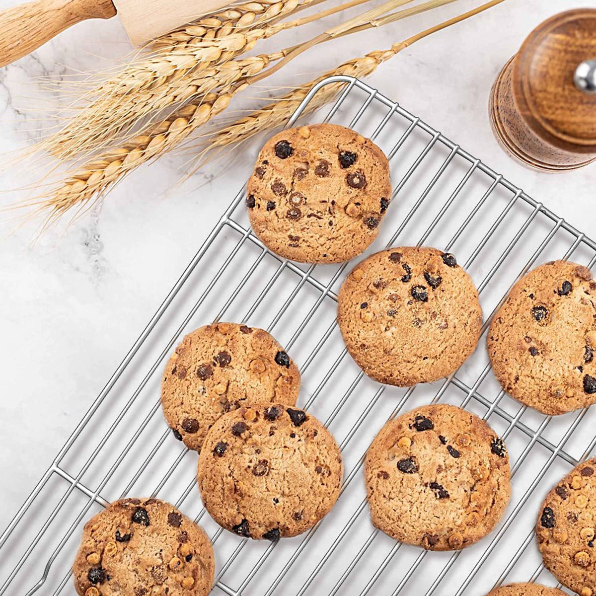 Stainless steel mini cooling rack set with wire grid holding cookies for cooling