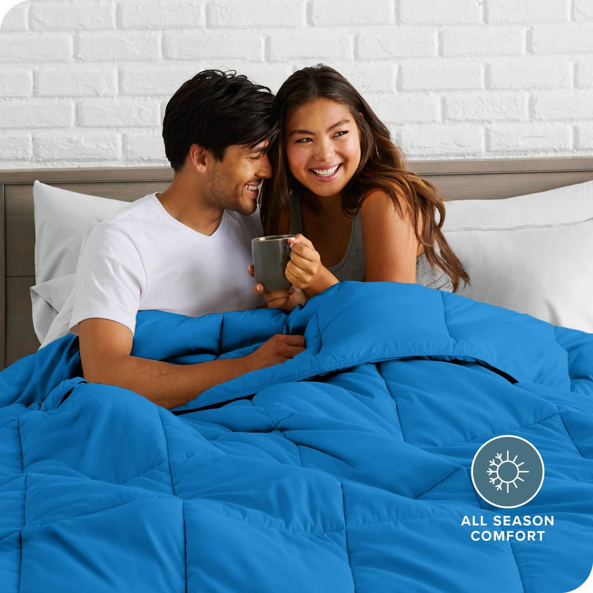 Blue comforter set with pillow shams on bed, all-season style