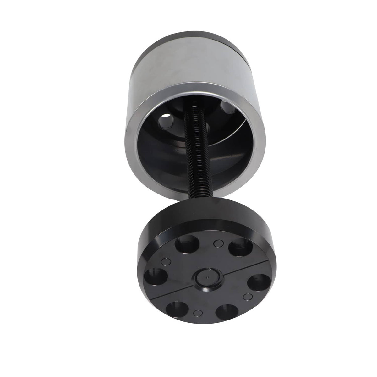 Bushing installation tool with threaded rod and black base plate with holes