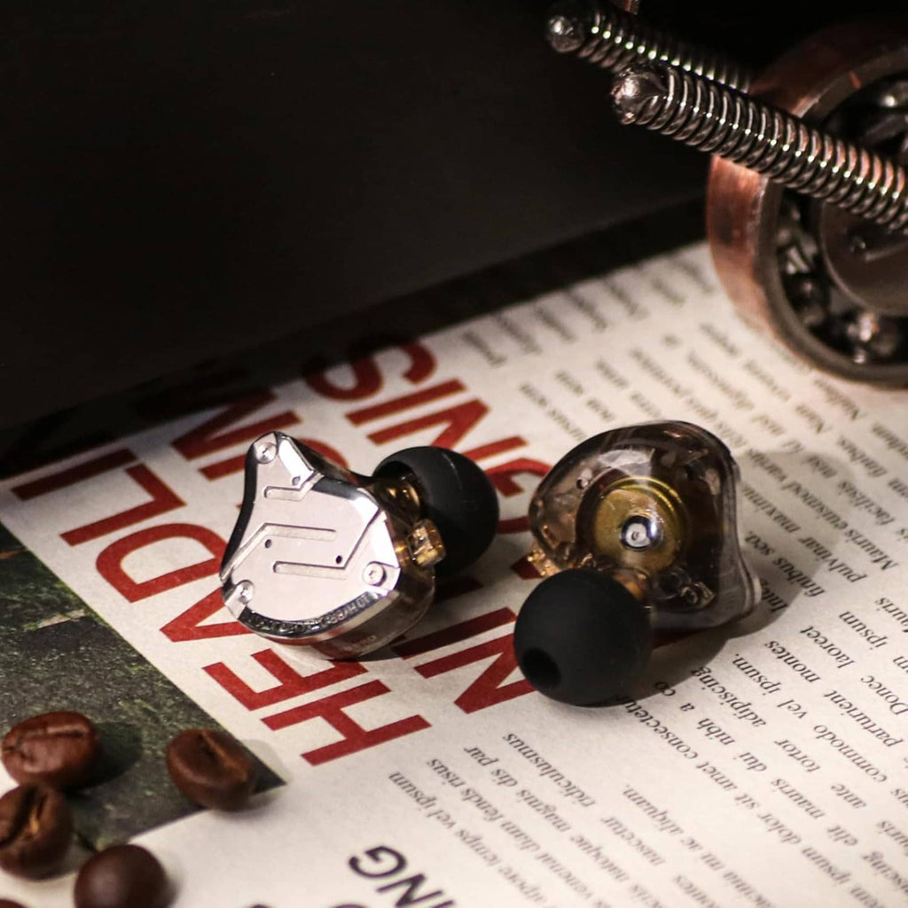 In-ear monitors and clear cable with black silicone tips, close-up angle