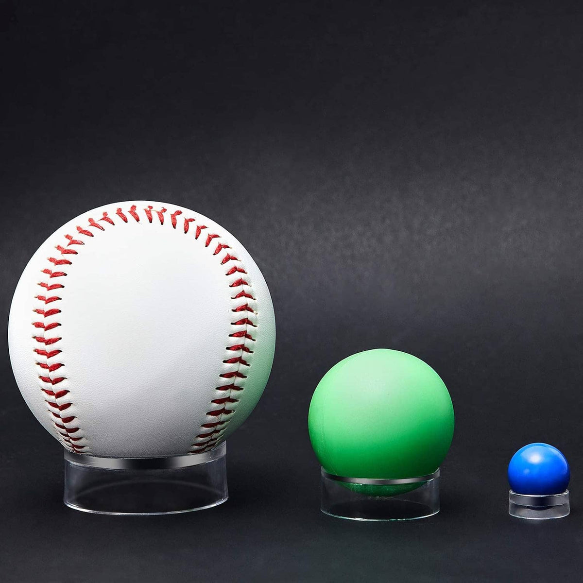 Clear acrylic sphere stands holding a baseball on one and colored balls on others
