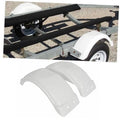 Pair of white trailer fenders mounted over trailer wheels and tires