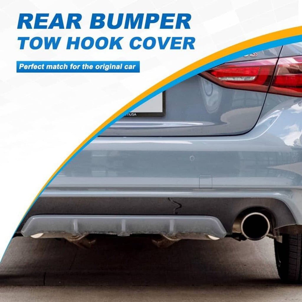 Rear bumper tow hook cover opening area with dark surround on car bumper