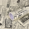 Vintage newspaper-style peel-and-stick contact paper roll on a neutral background
