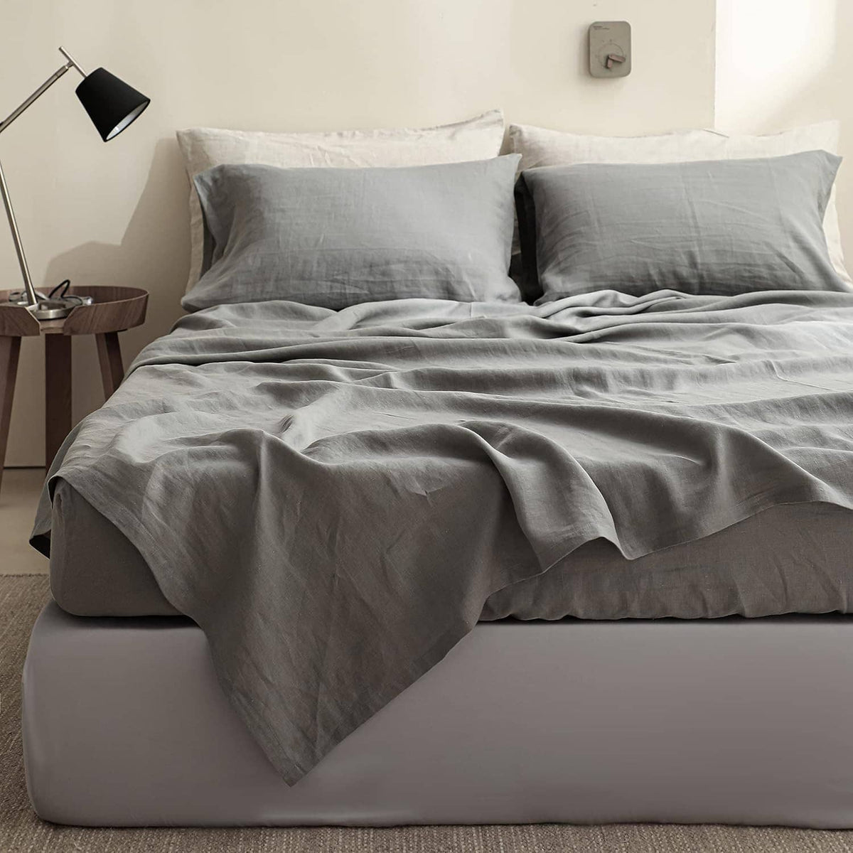 Gray linen fitted mattress cover with smooth top and fitted elastic skirt