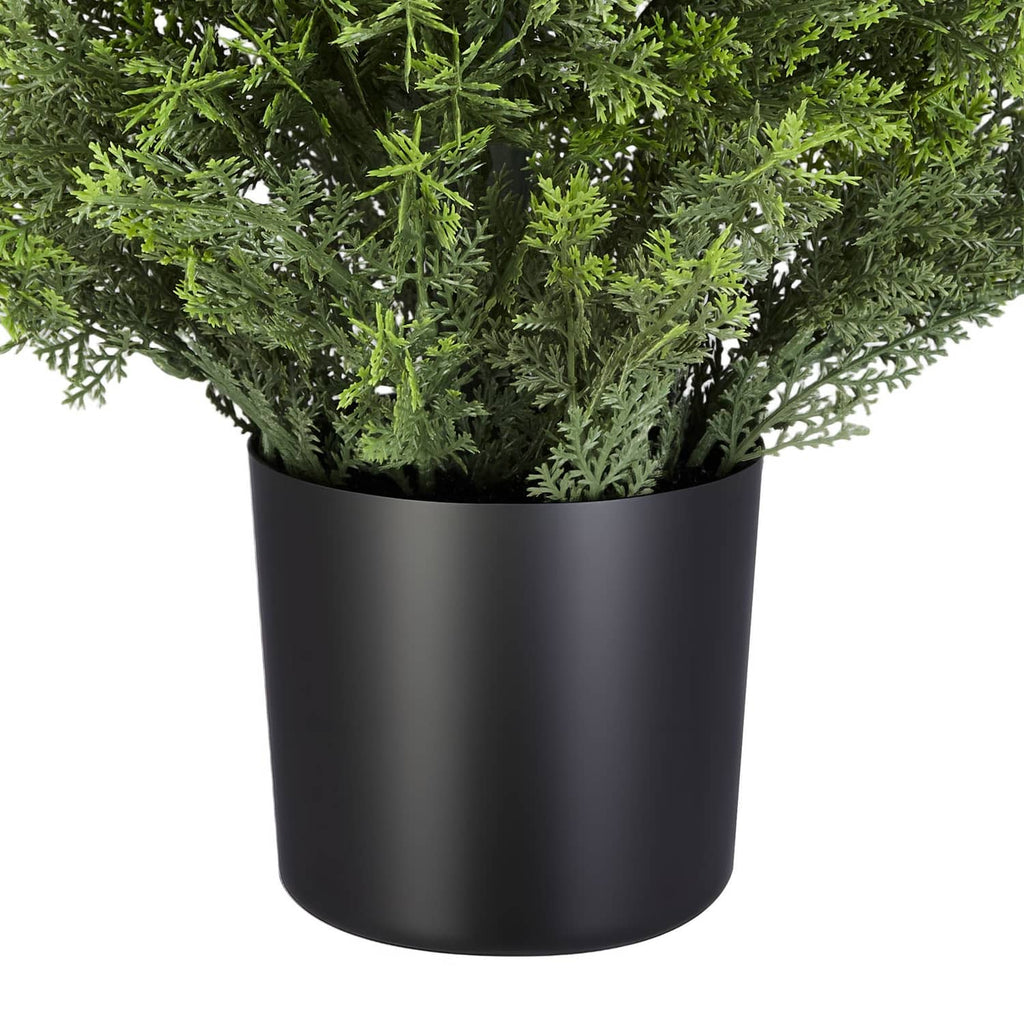 Artificial cedar tree in black planter pot with full green foliage