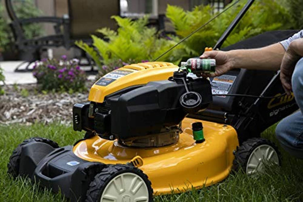 Green Sta-Bil Fast Fix small engine treatment bottle near lawn mower engine