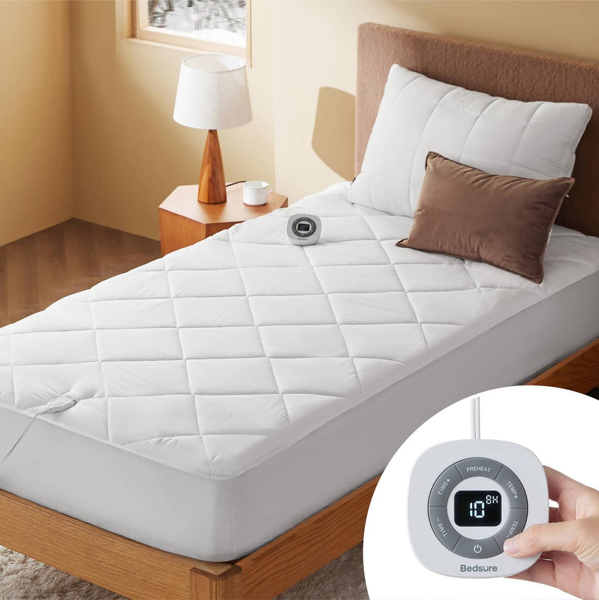 White twin heated mattress pad with remote controller on bed surface