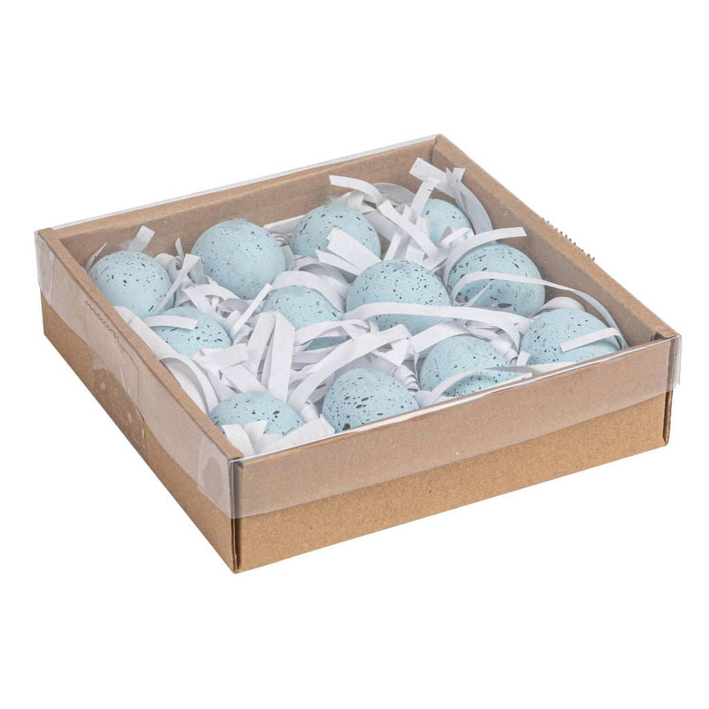 Blue speckled ceramic eggs in open cardboard gift box with white ribbon