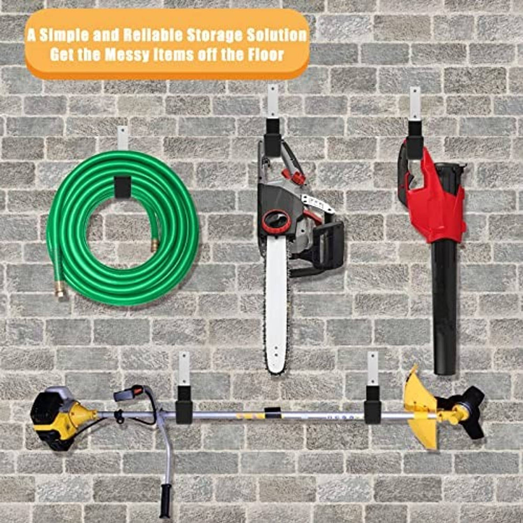 Black U hooks mounted on a brick wall holding tools and cords
