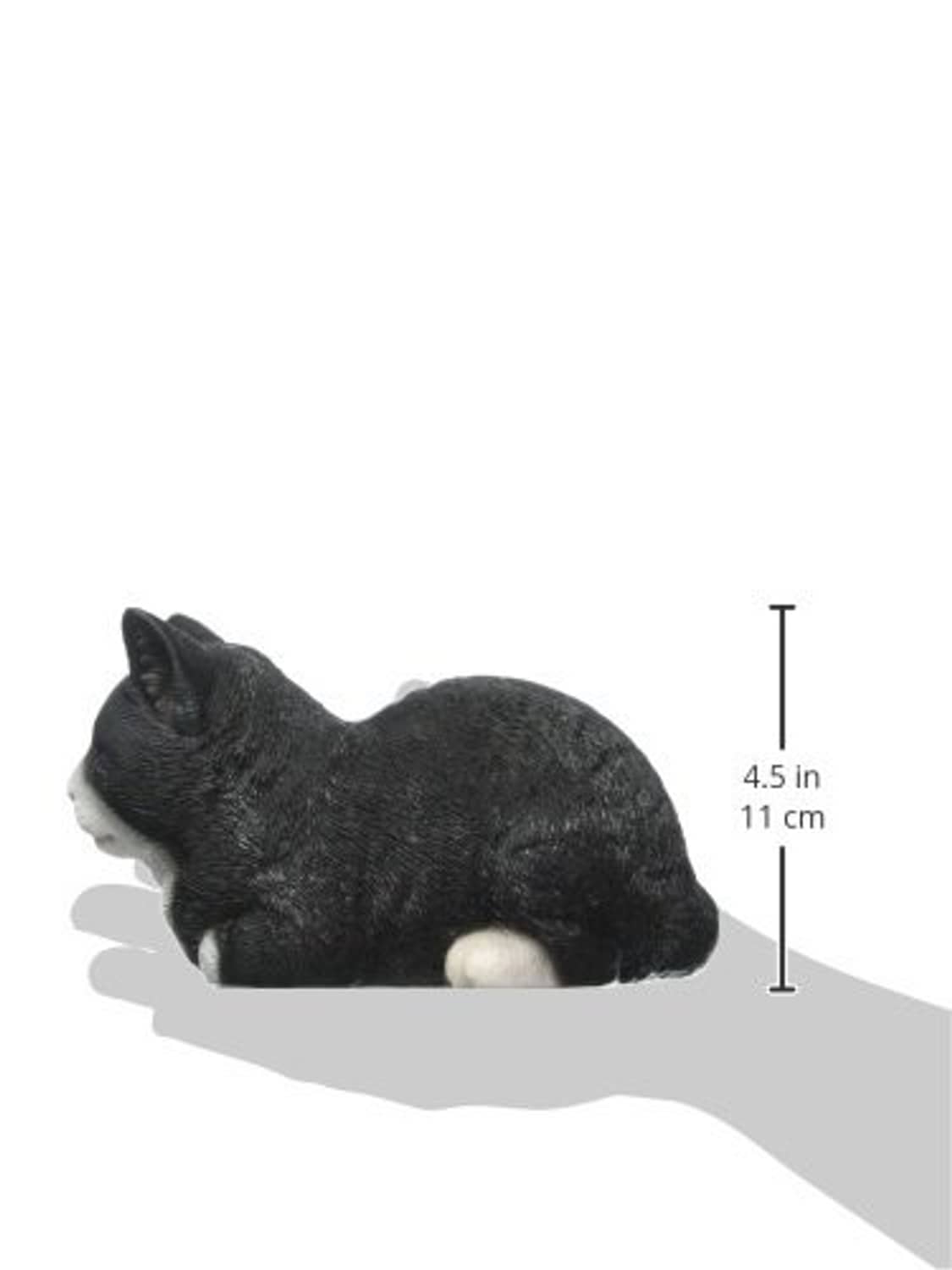 Sleeping cat statue, black with white paws, lying on side (approx. 4.5 in)
