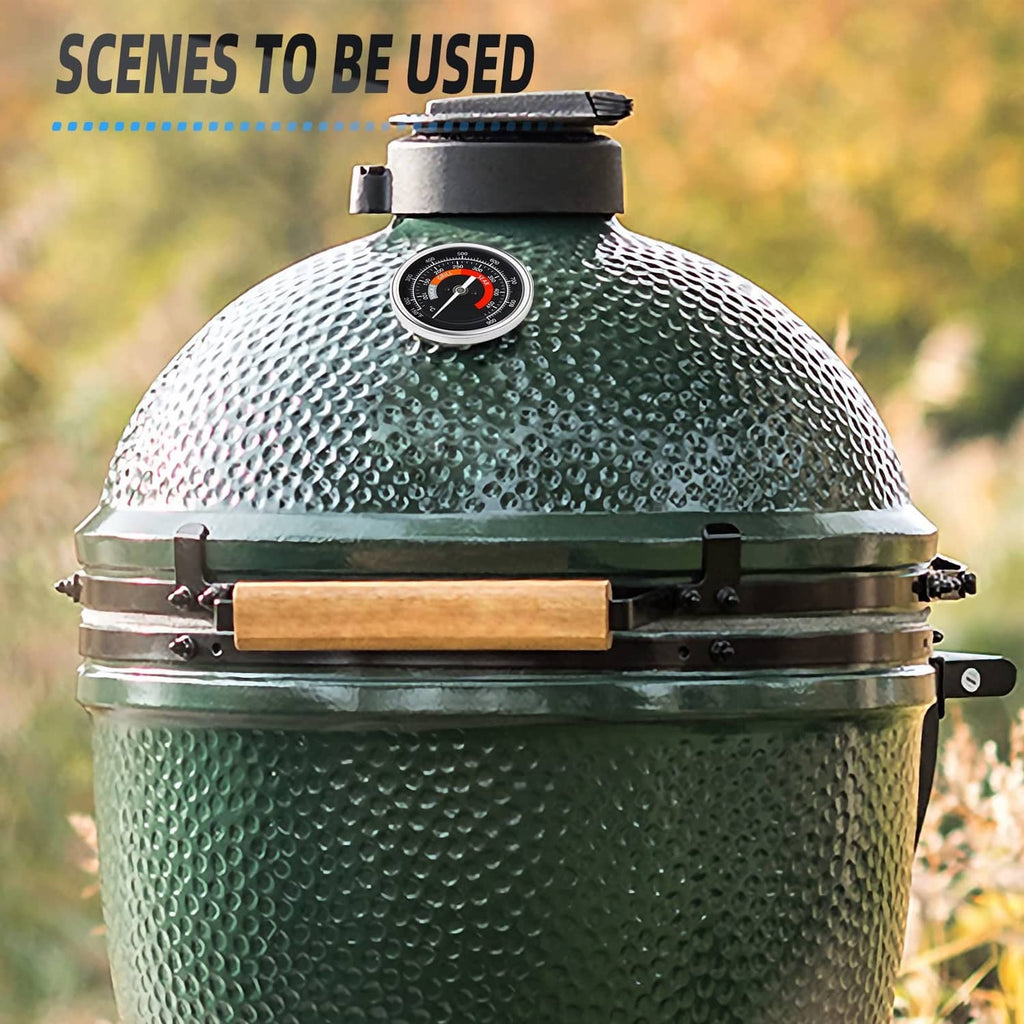 Circular grill thermometer dial mounted on green textured egg-style grill lid