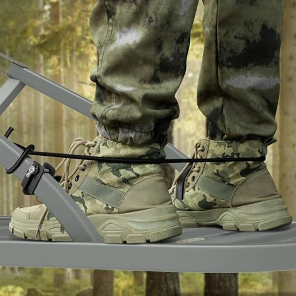 Camouflage boots on a climbing stand with black stirrup bracket and elastic rope loops