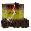 Backflow incense cones box with dark brown cones and wisps of smoke