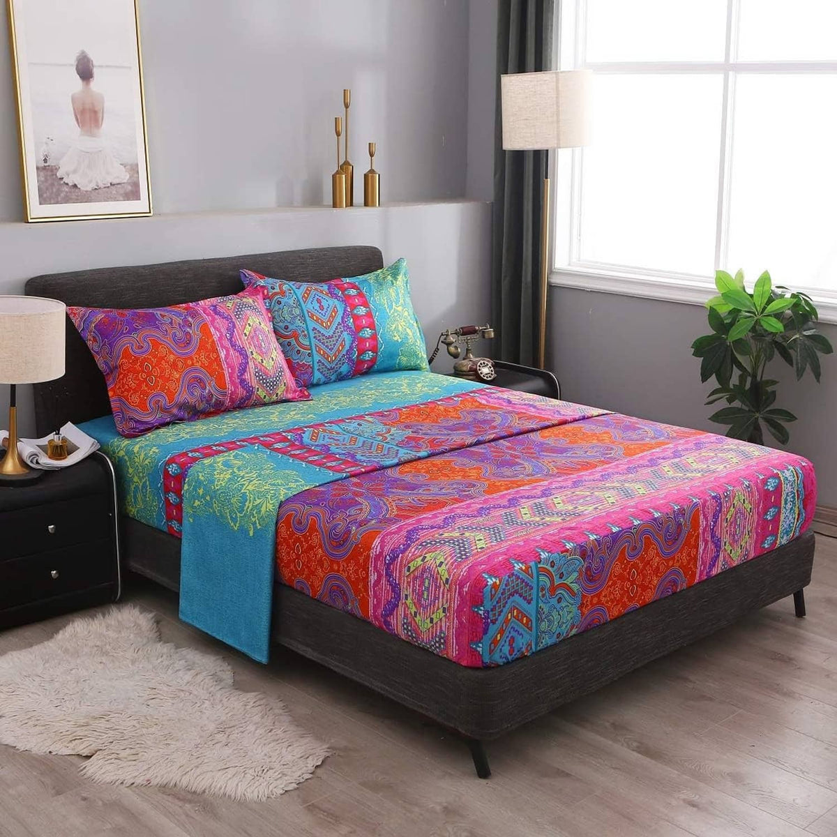 Colorful boho paisley bedding set on bed with matching pillow cases and flat sheet