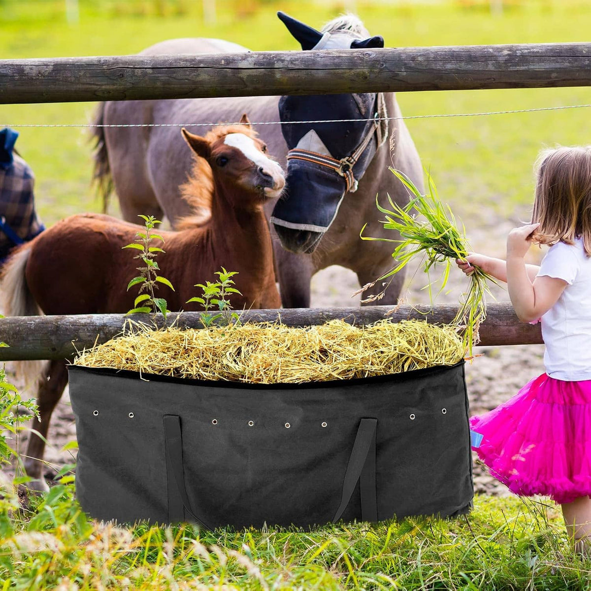 Black hay storage bag with hay inside and side grab handles for easy access