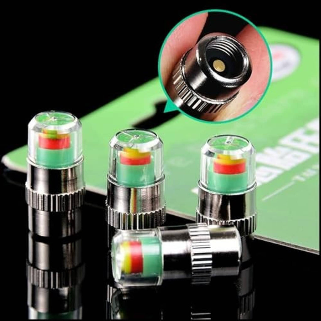 Close-up of silver tire pressure monitor valve caps with colored indicator bands