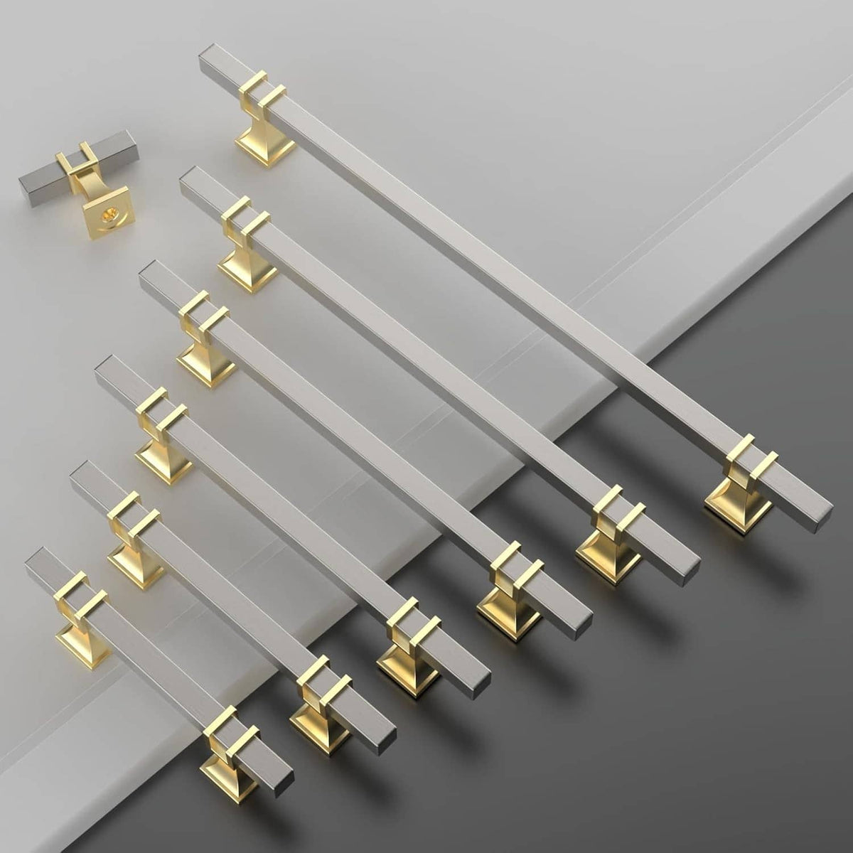 Brushed satin nickel and gold cabinet knobs laid out, square base, metal finish