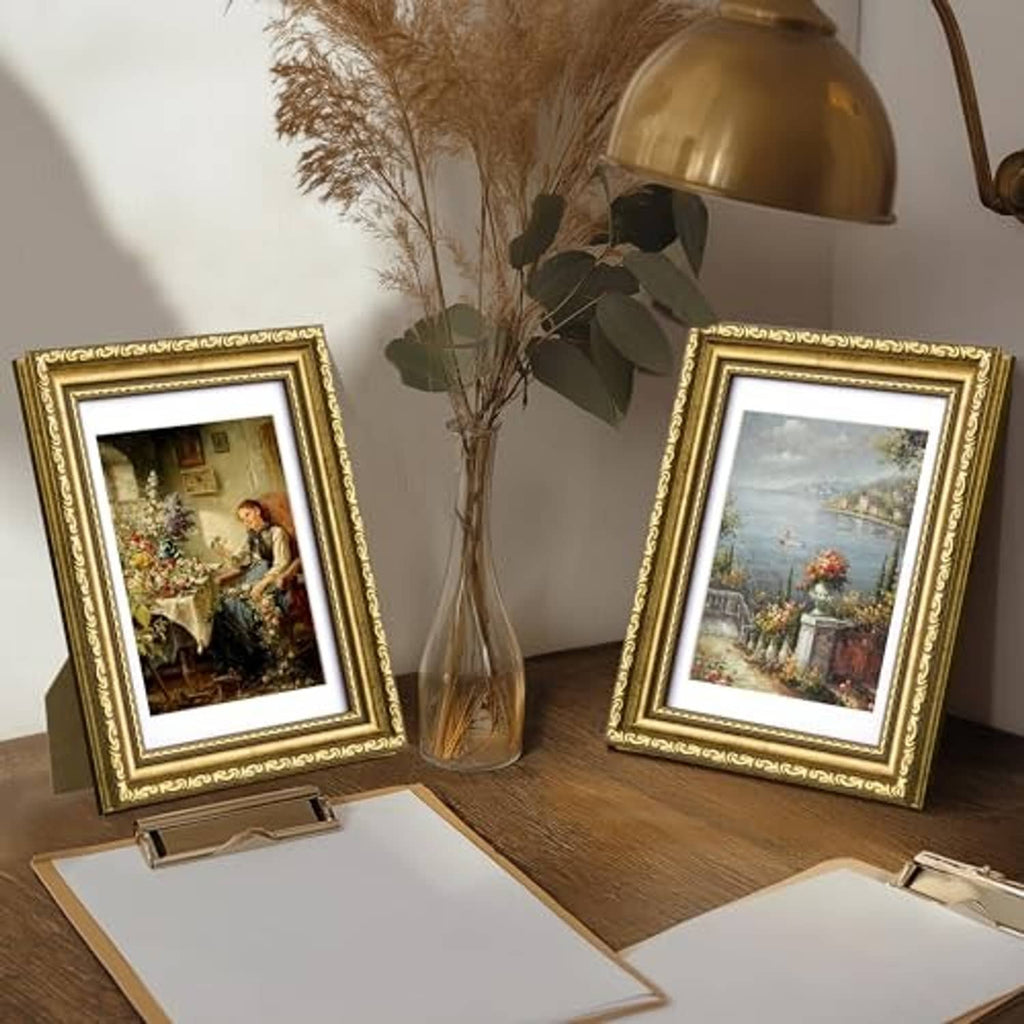 Gold ornate picture frame set of 2 standing with photos on a tabletop