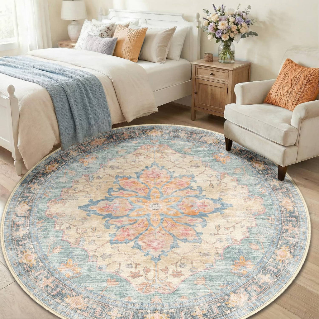 Round washable area rug with blue base and floral medallion design in orange and red